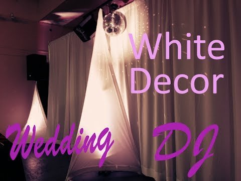 Wedding dj set up with white scrim king speaker cover